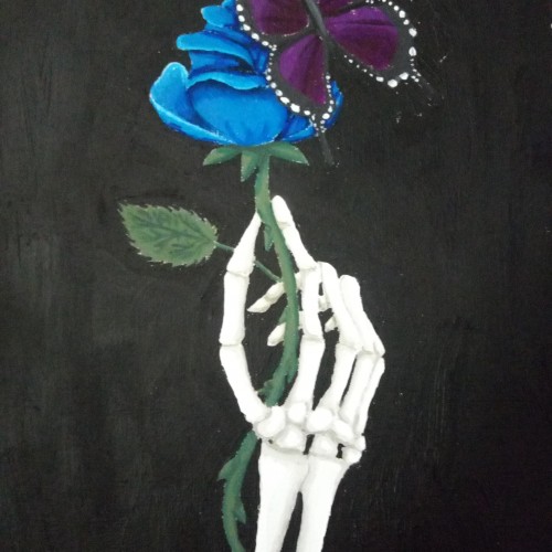 Skeleton hand holding a rose